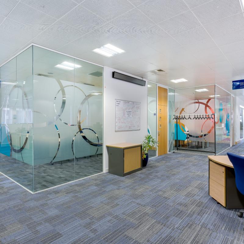 view of open plan office with conference room emtrance