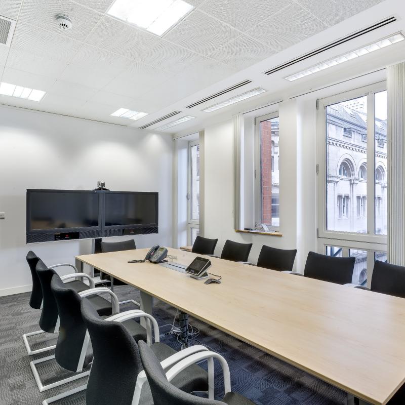 view of video conferencing room to seat 12 people round long narrow table