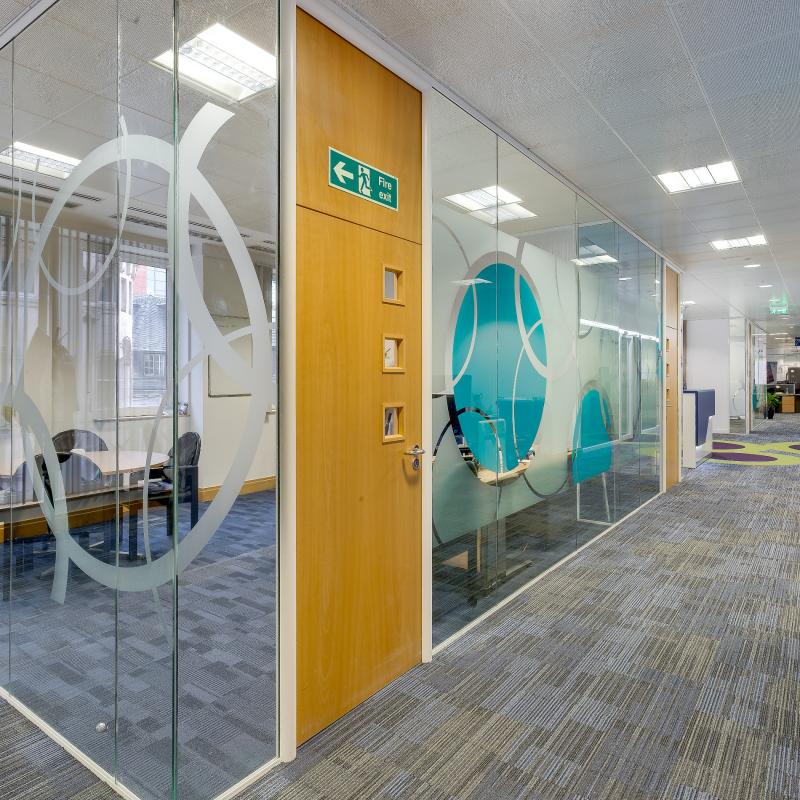 view with glazed offices on left of main corridor leading to reception