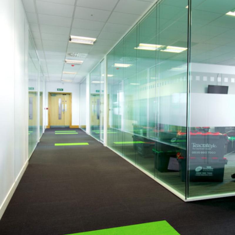 view of corridor with glazed meeting rooms to righthand side