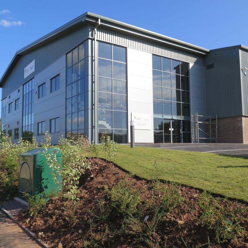 external view of new factory with two storey glazed office end nearest to entrance