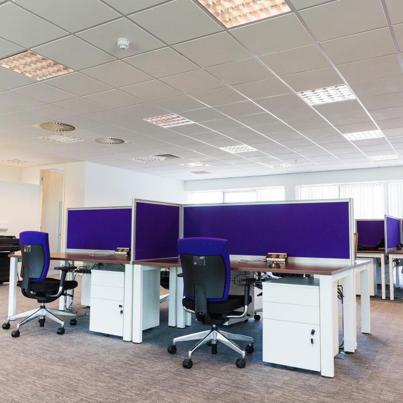 view of open plan desking with tall dividing screens in crucifix layout